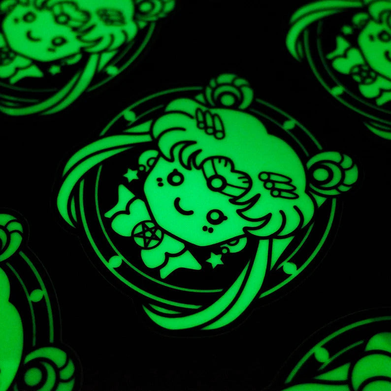 Custom glow-in-the-dark Halloween ghost sticker shown in daylight and glowing after exposure to light